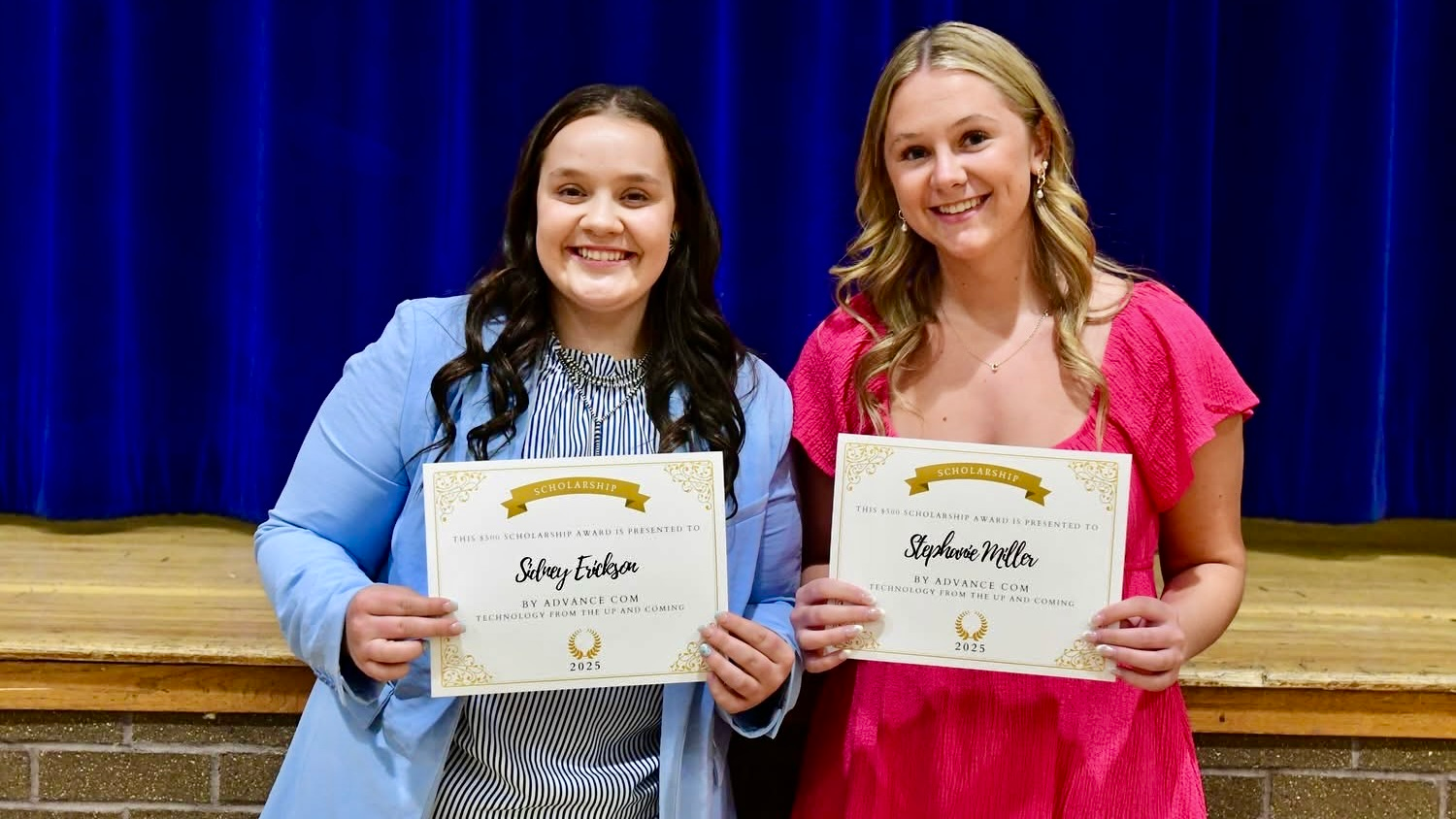 Two students recieving a scholarship