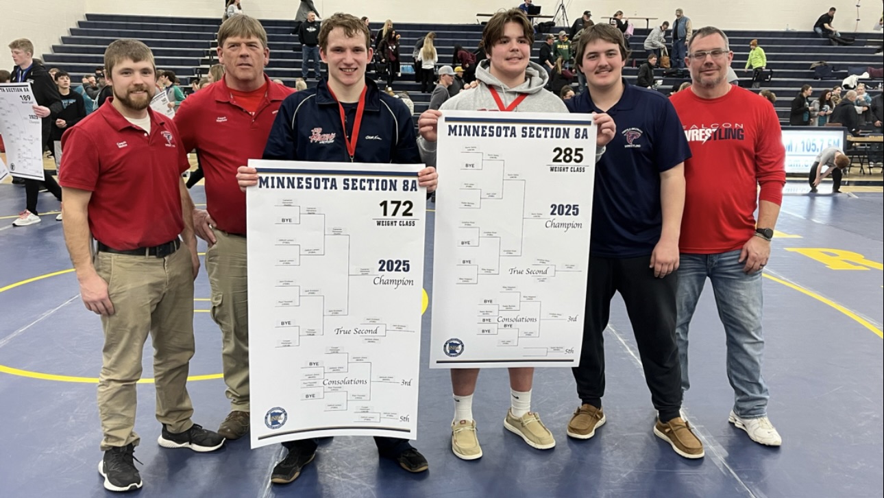Photo of Jack Erickson and Jack Leiser holding their weight bracket poster to advance them to the state tournament